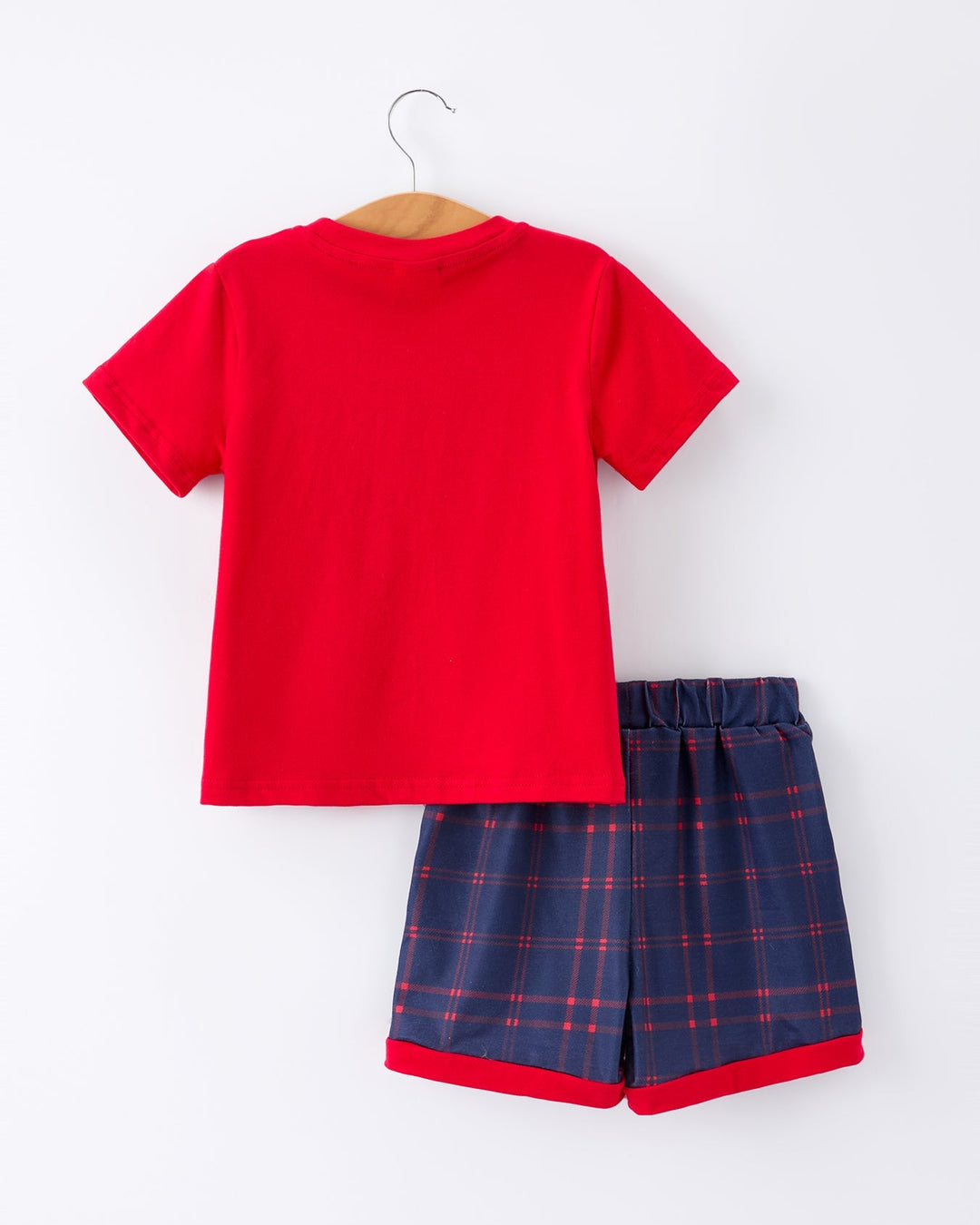 Red t-shirt and blue plaid shorts set on a white background