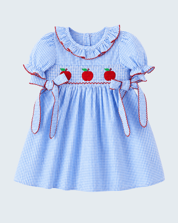 Blue checkered dress with red apple details on a light gray background