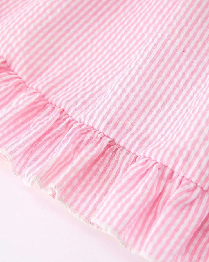 Close-up of a pink textured fabric with ruffled edge