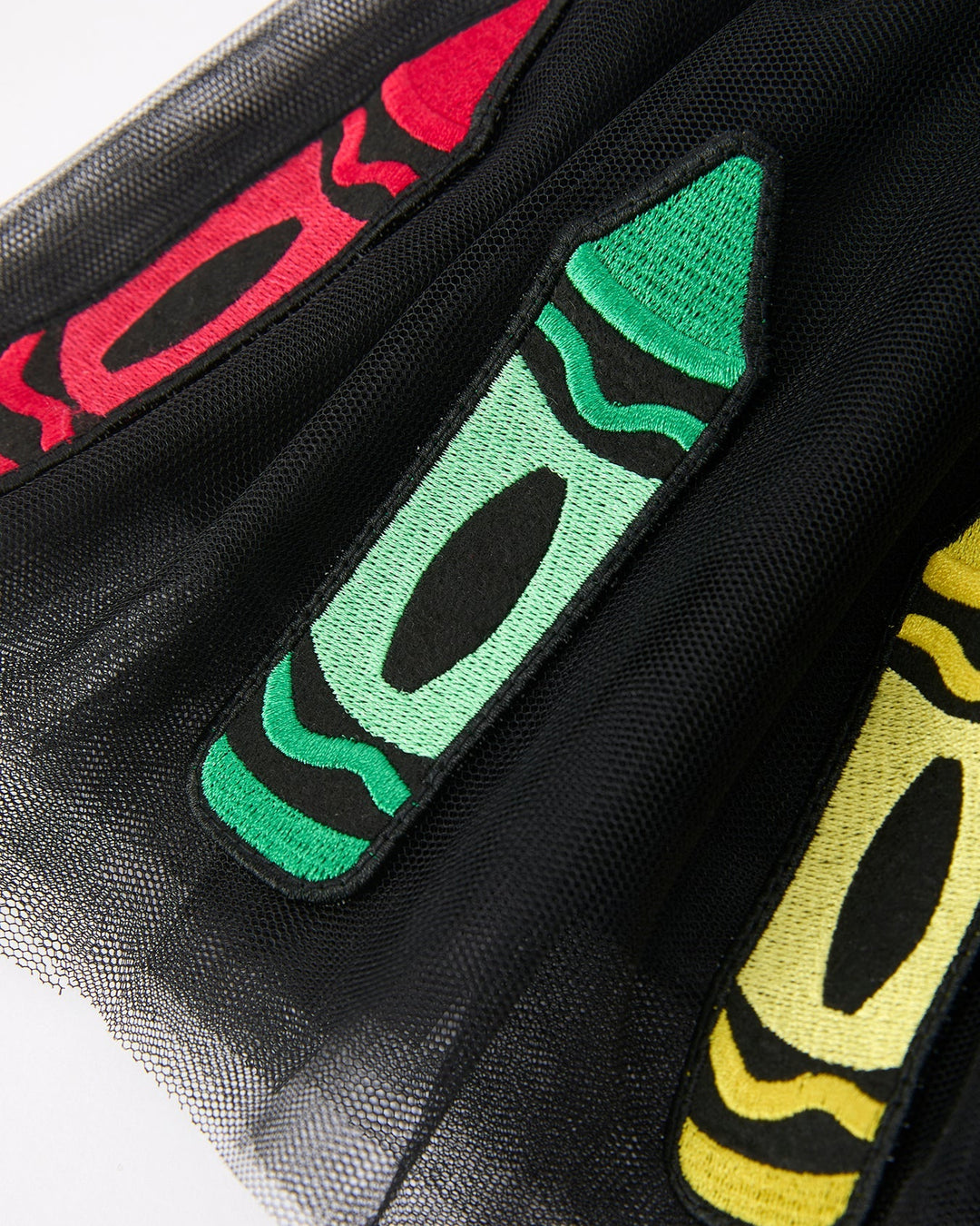Colorful crayon-shaped patches on a black background