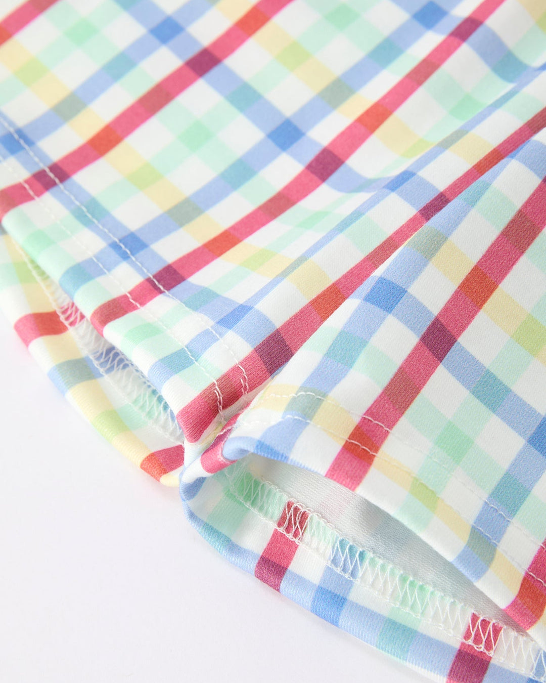 Colorful plaid fabric with a brand logo on a white background