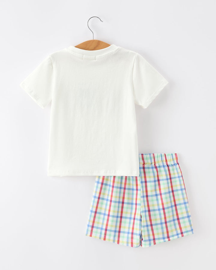 White t-shirt and plaid shorts set on a white background