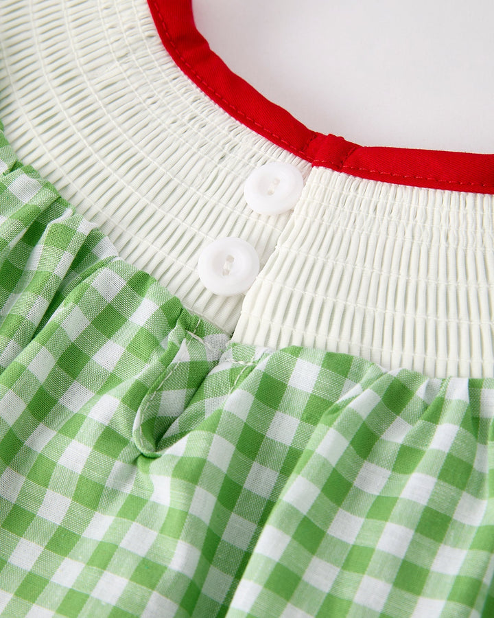 Close-up of a green and white checkered dress with a red trim.