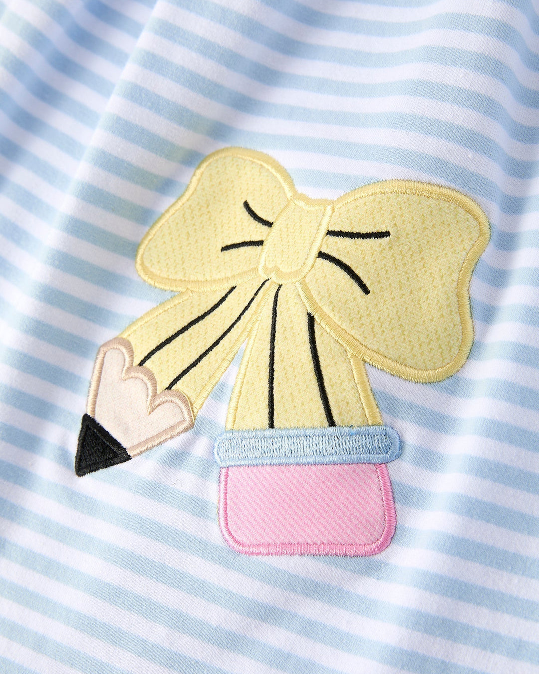 Patch of a pencil with a bow on a striped background