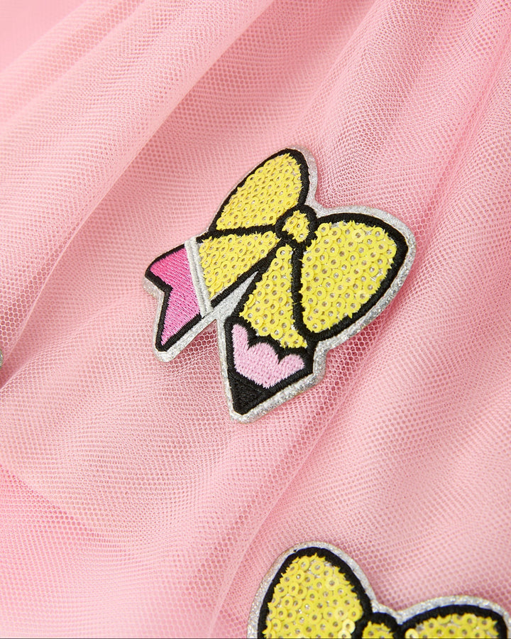 Yellow bow patch with rhinestones on a pink fabric background