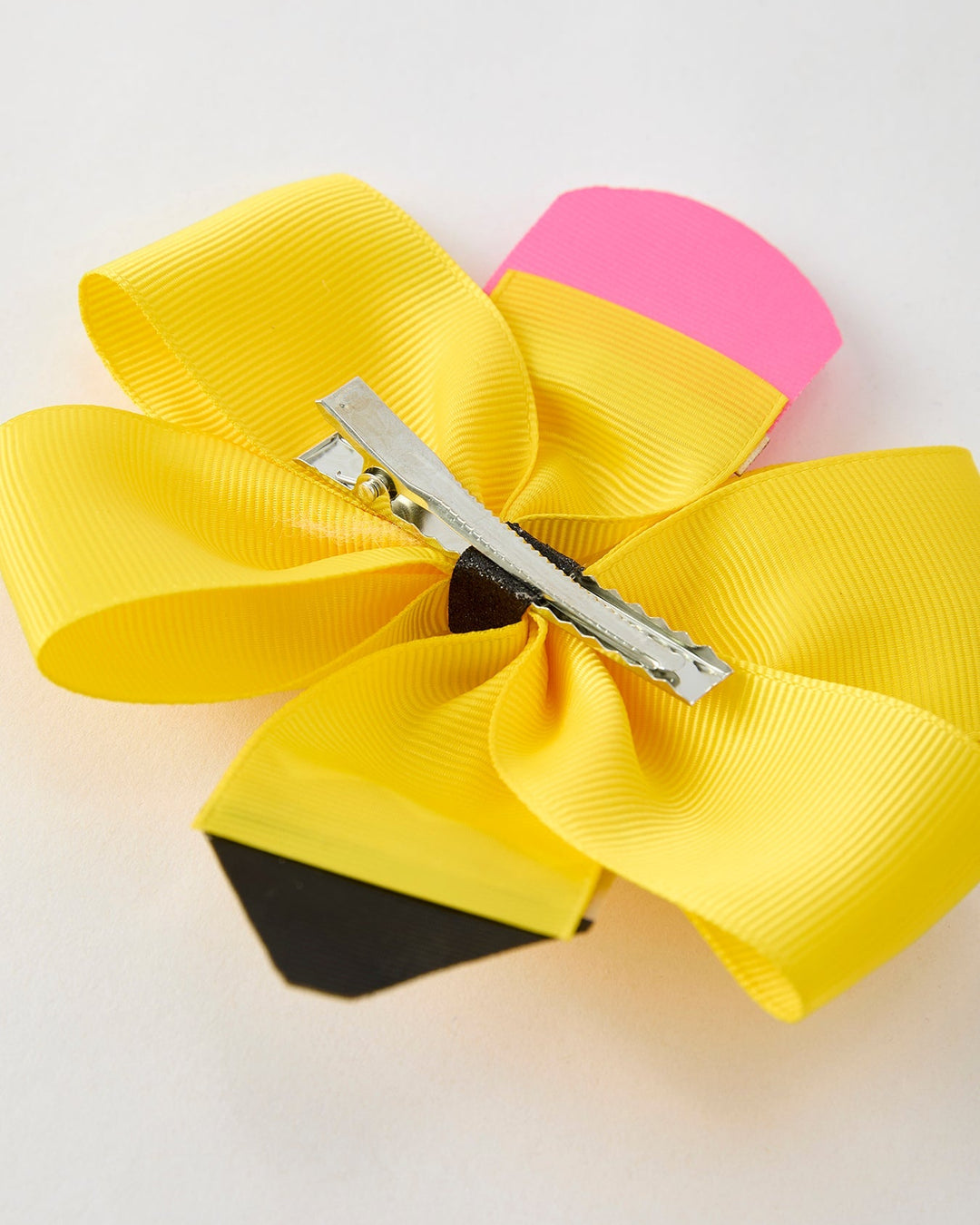 Colorful hair bow with a clip on a light background