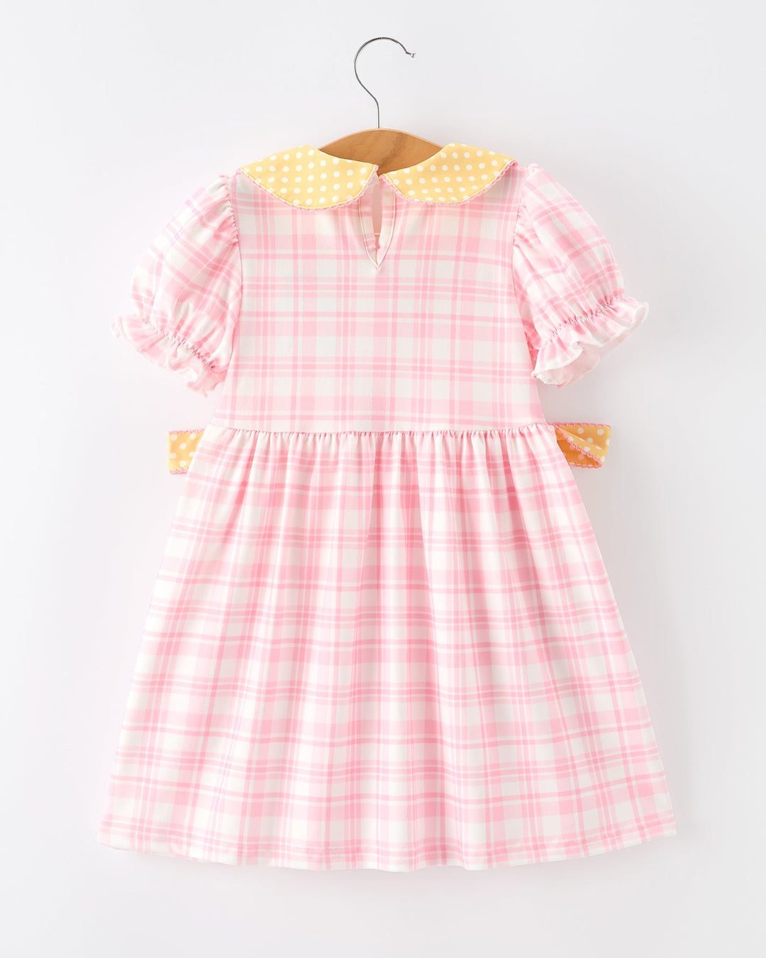Pink checkered dress with yellow collar on a white background