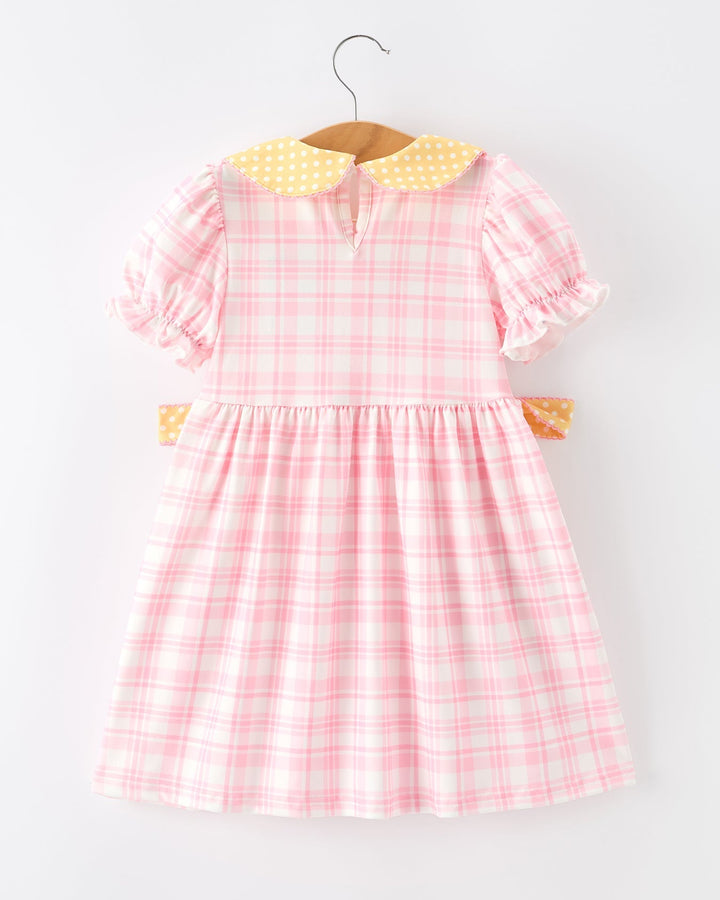 Pink checkered dress with yellow collar on a white background