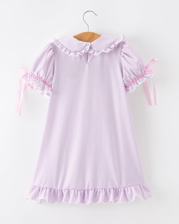 Pink dress with ruffled details on a white background