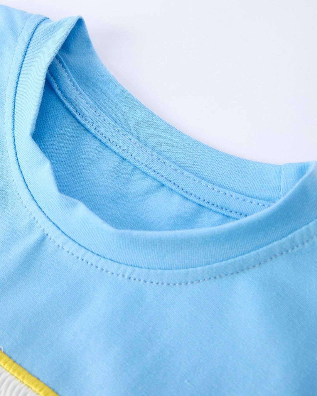 Close-up of a blue garment with a white background