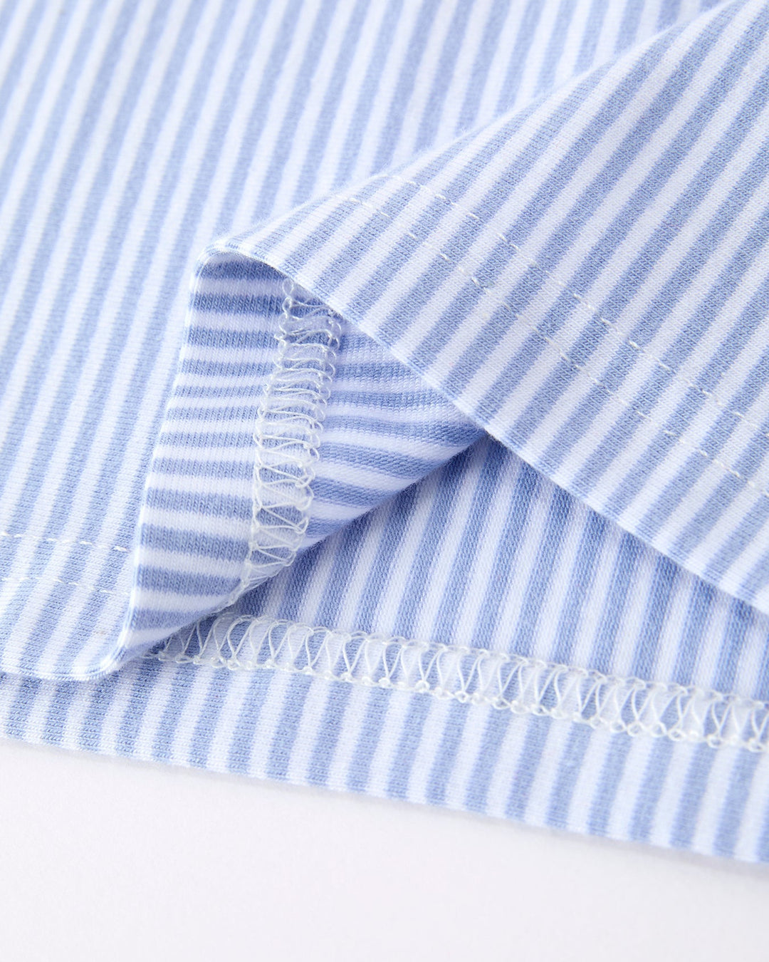 Close-up of blue and white striped fabric with a white background