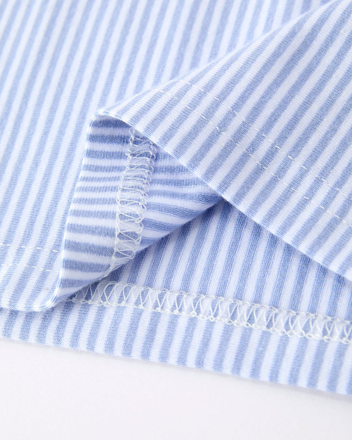 Close-up of blue and white striped fabric with a white background