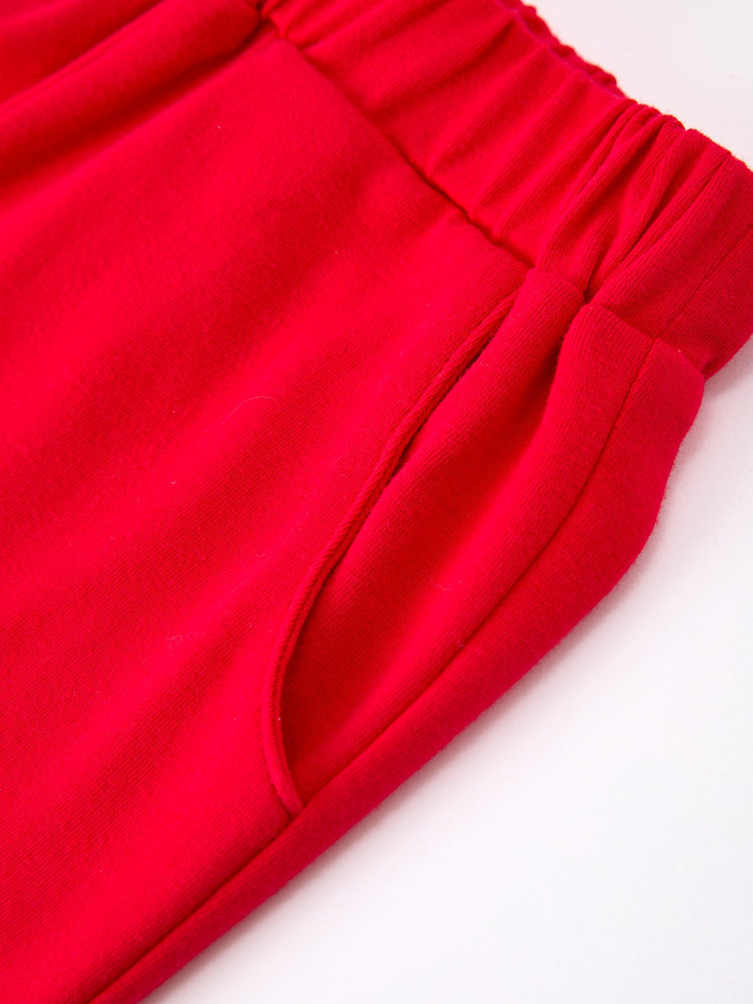 Close-up of red pants with an elastic waistband on a white background