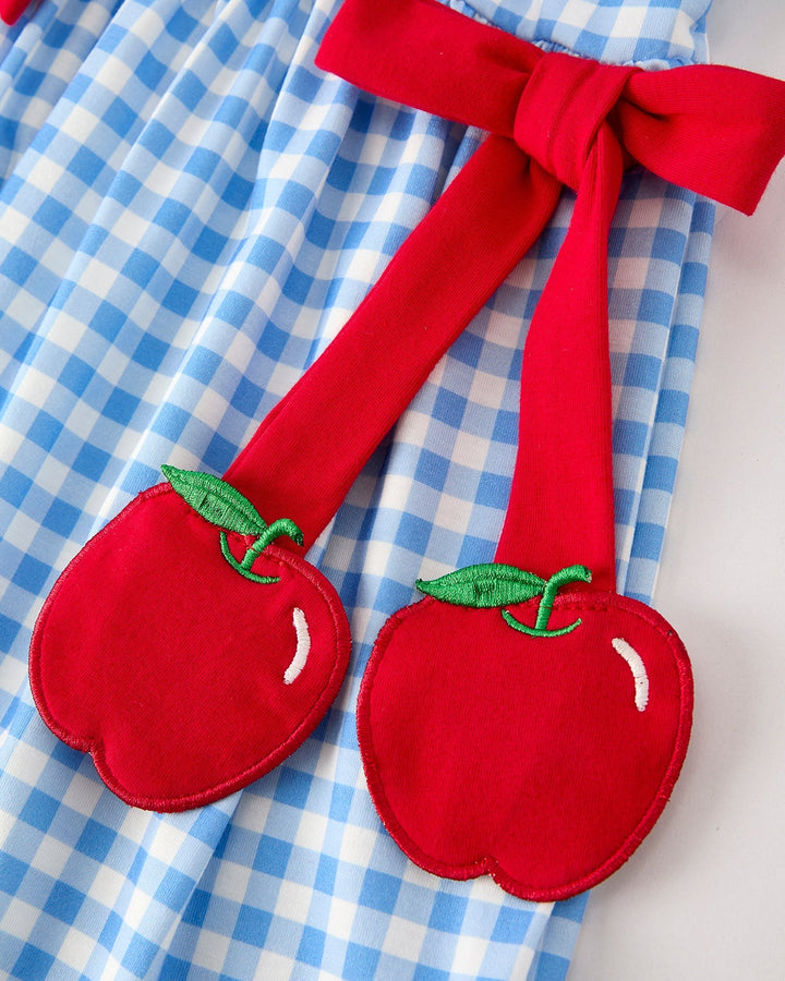 Dress with apple designs on a blue checkered background
