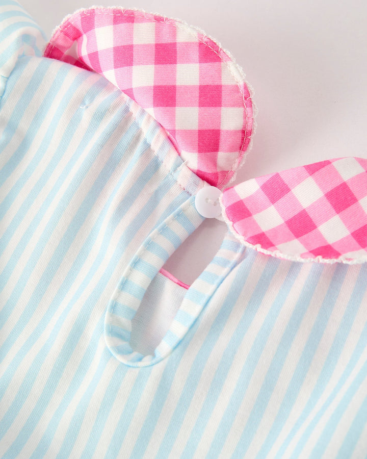 Dress with pink and white checkered design on a blue and white striped background