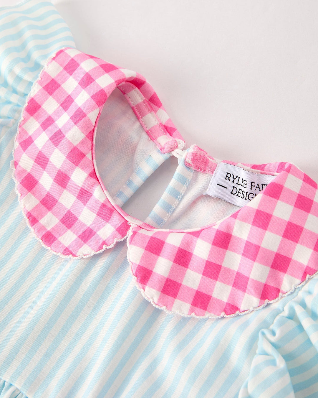 Pink gingham collar on a striped shirt with &