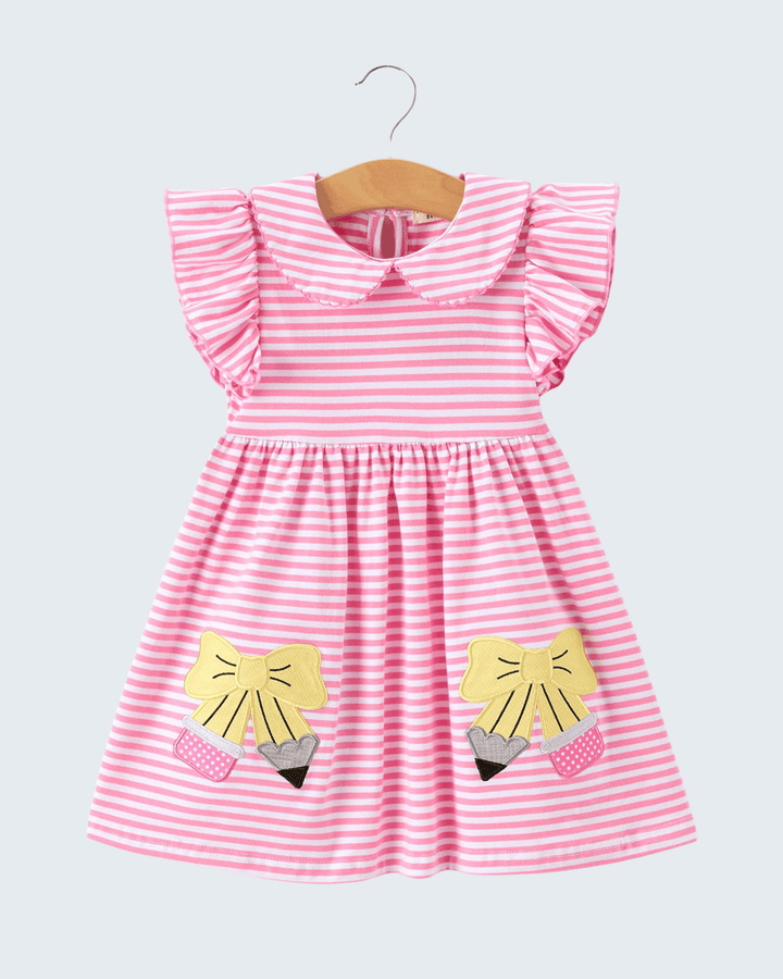 Pink and white striped dress with yellow fox appliqués on a hanger against a light gray background
