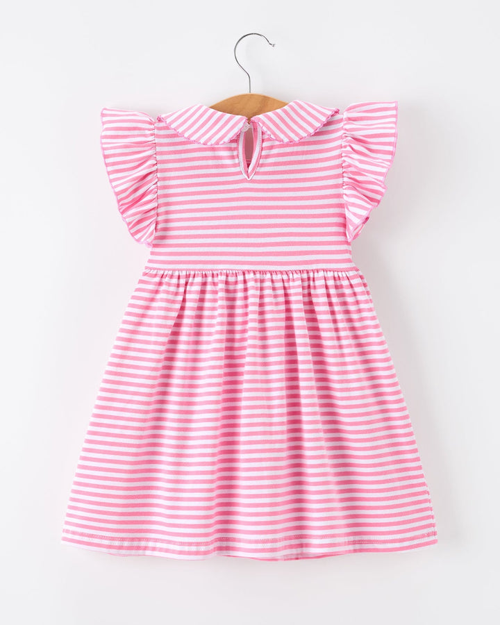Pink and white striped dress on a hanger against a white background