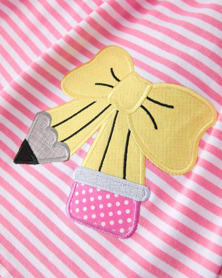 Yellow bow patch on a pink and white striped background