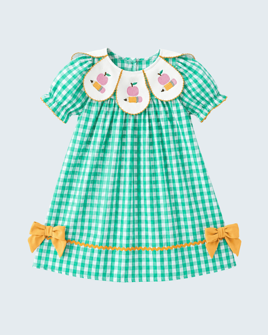 Green checkered dress with pink bunnies and yellow bows on a light blue background