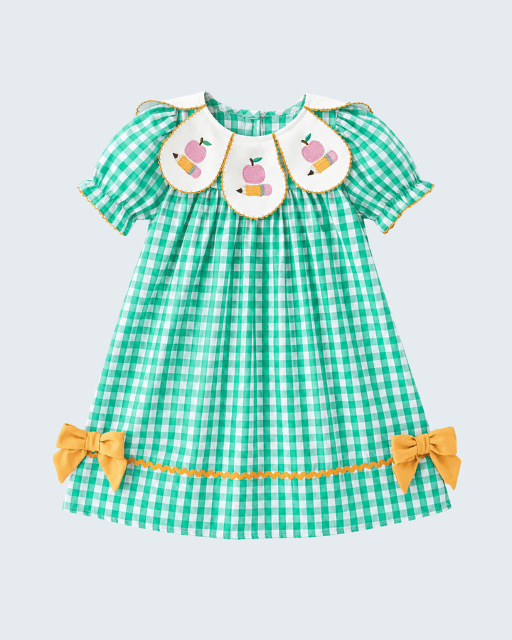 Green checkered dress with pink bunnies and yellow bows on a light blue background