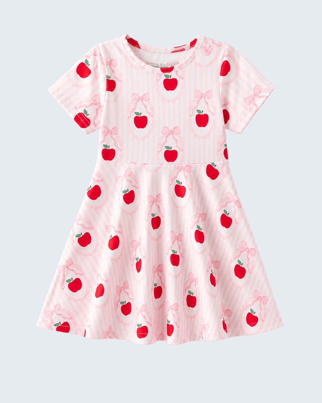 Pink dress with apple and bow pattern on a light gray background