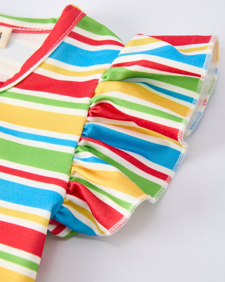 Colorful striped garment with ruffled edges on a light gray background