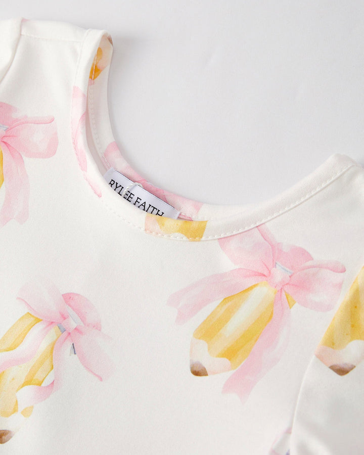 White garment with floral pattern and visible brand label on a light background