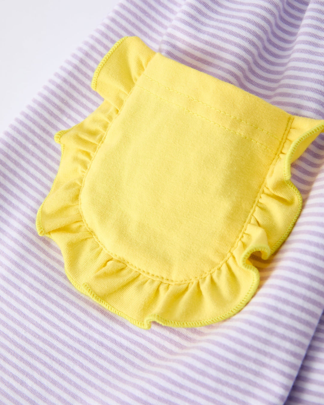 Yellow pocket on a striped fabric background