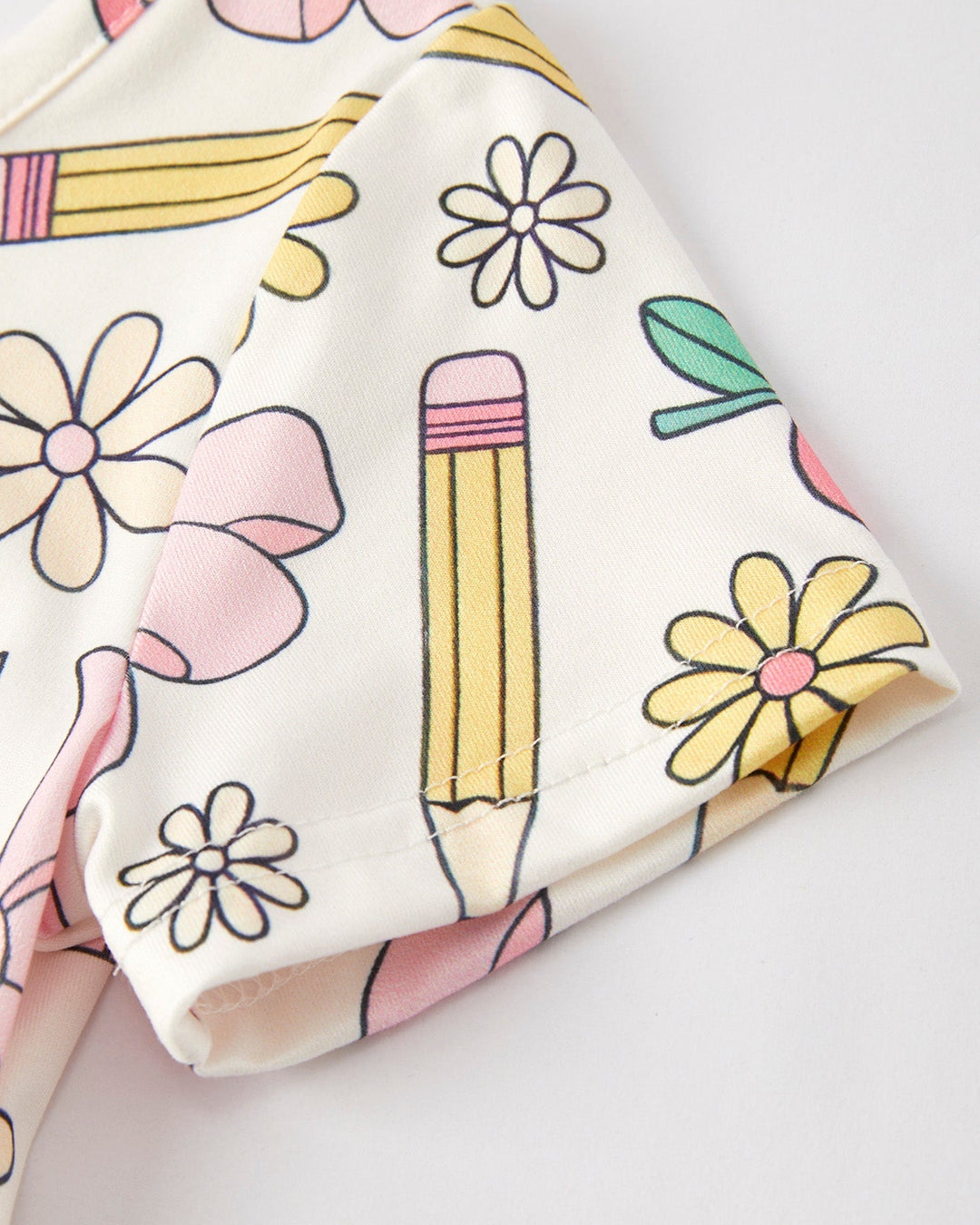 Fabric with colorful pencil and flower pattern on a white background