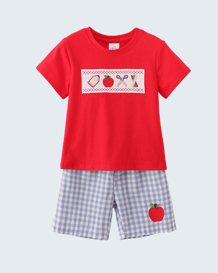 Red t-shirt with a graphic and checkered shorts on a light blue background