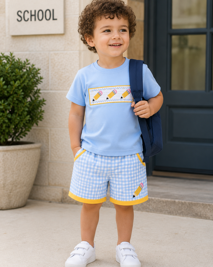 Young boy in back to school light blue outfit with pencil applique