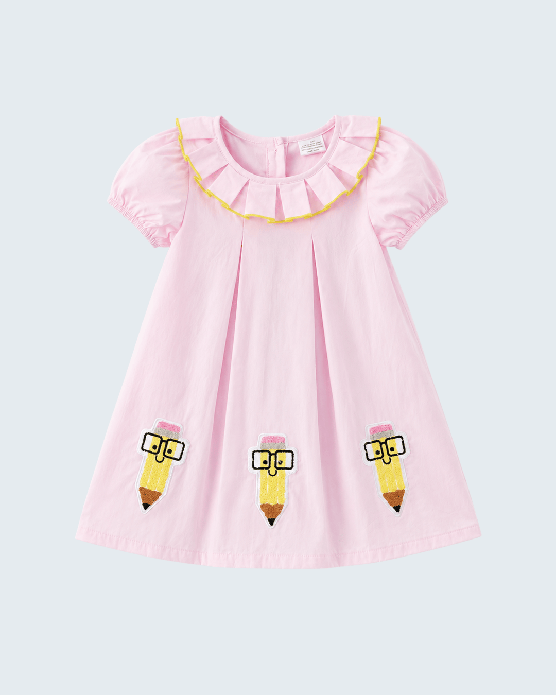 Pink dress with pencil designs on a light gray background
