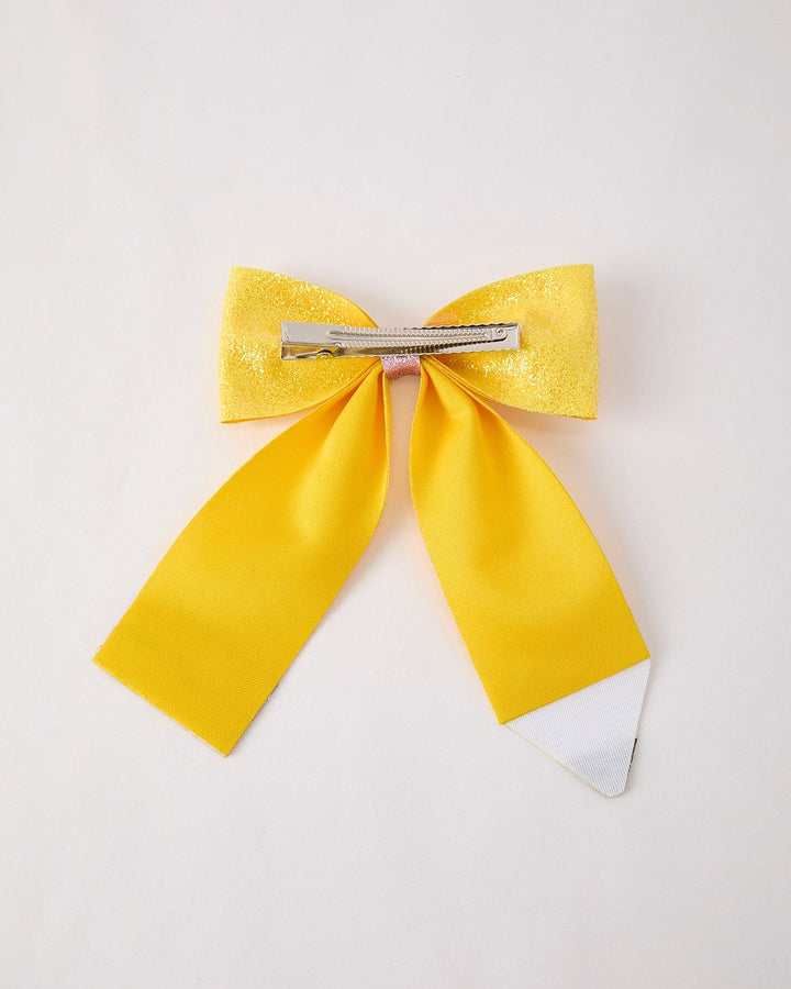 Yellow hair bow with a clip on a white background