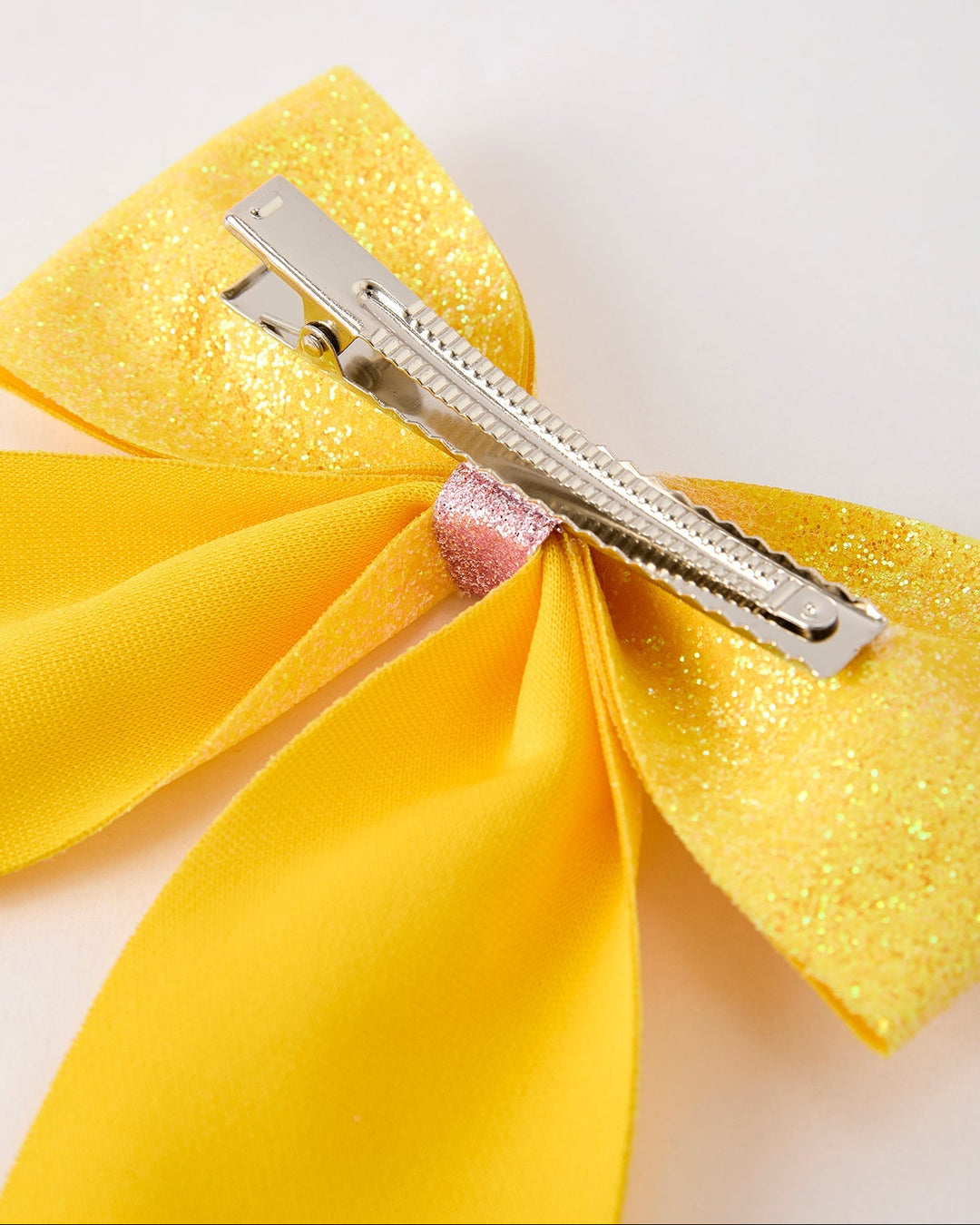 Yellow bow hair clip on a light background
