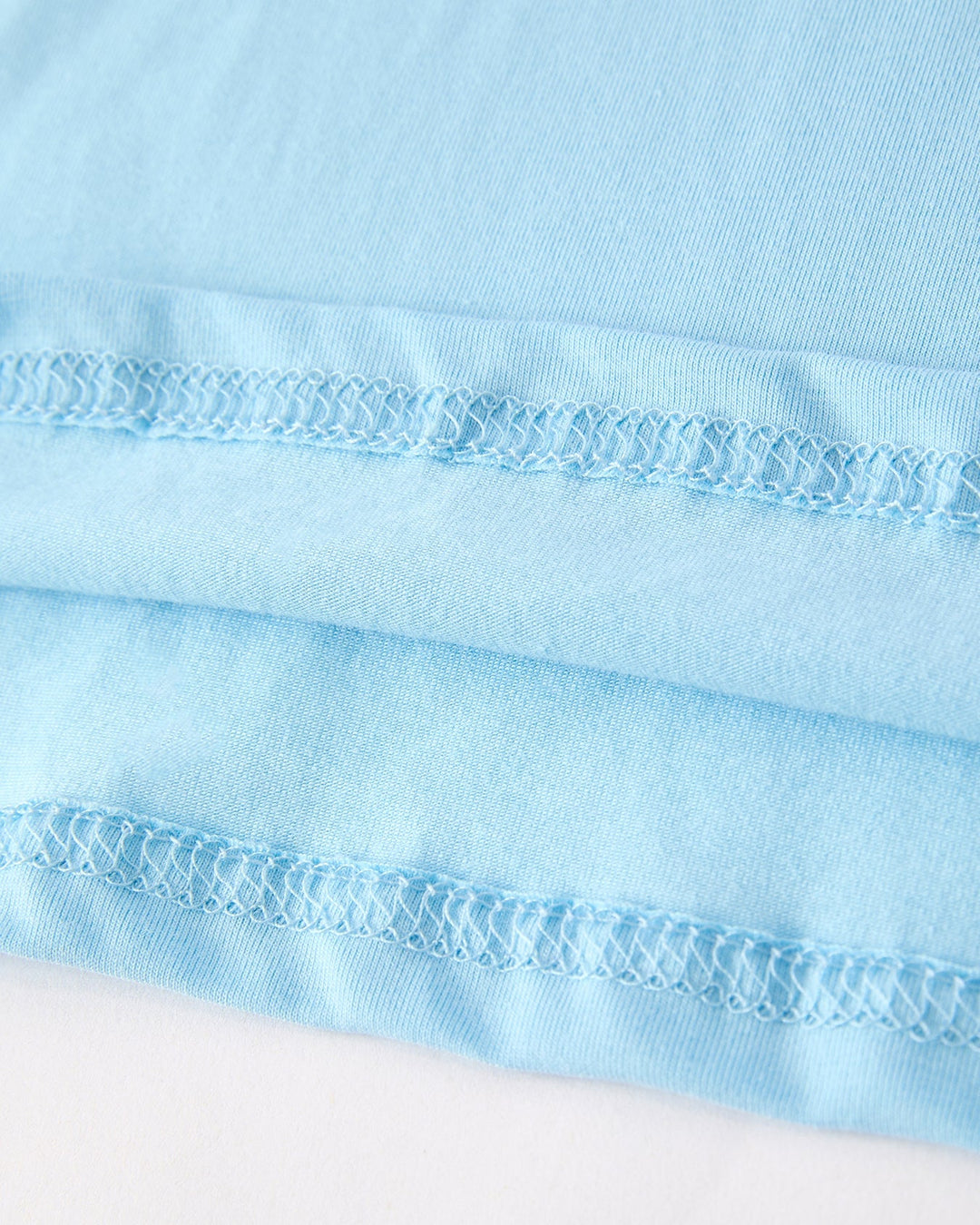 Close-up of light blue fabric with a textured pattern