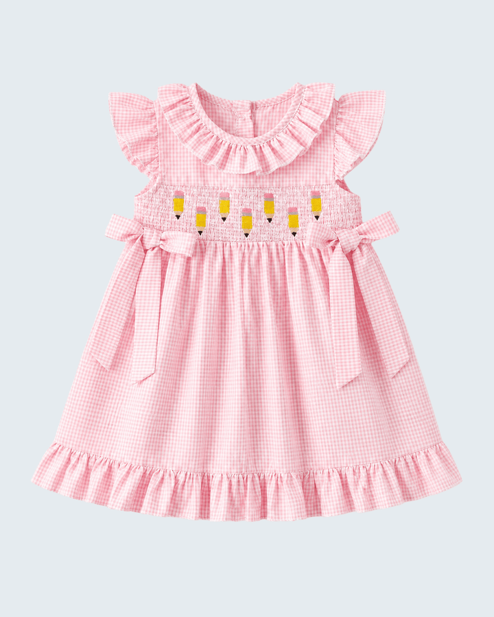 Pink checkered dress with ruffled sleeves and yellow accents on a light gray background