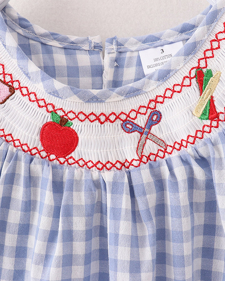 Blue and white checkered dress with red smocked trim and embroidered details on a plain background