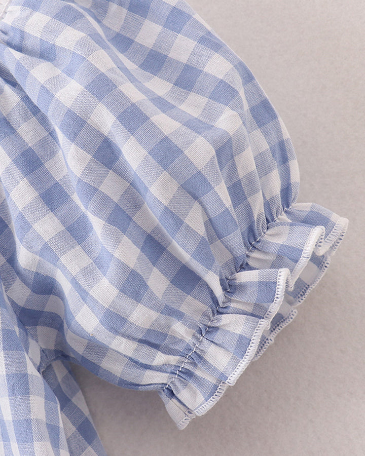 Close-up of blue and white checkered fabric on a neutral background