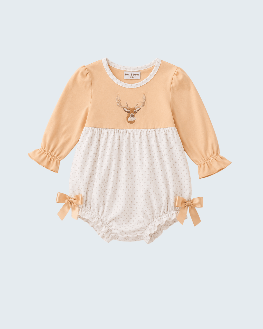A baby long-sleeve romper with a peach-colored top half featuring a deer graphic, and a white polka-dot bottom half with ruffled trim and matching peach ribbon bows at the legs.