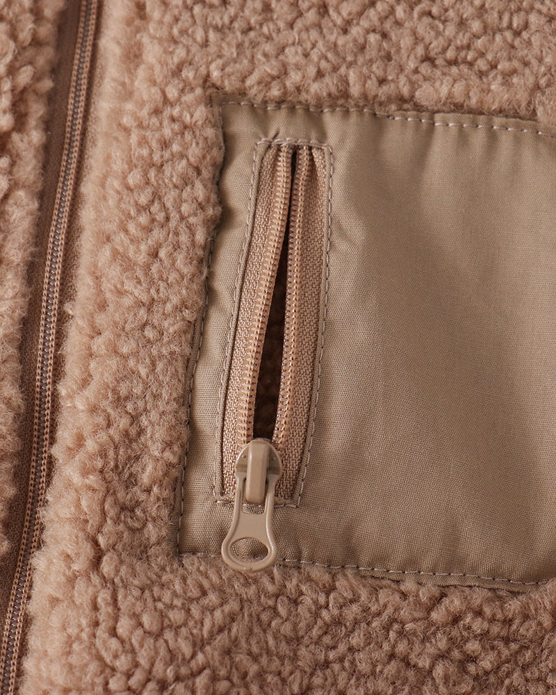 Beige fleece jacket detail: front zipper and flap pocket with lining