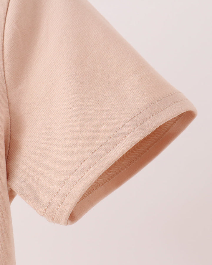 Light peach short-sleeve T-shirt showing stitched sleeve hem