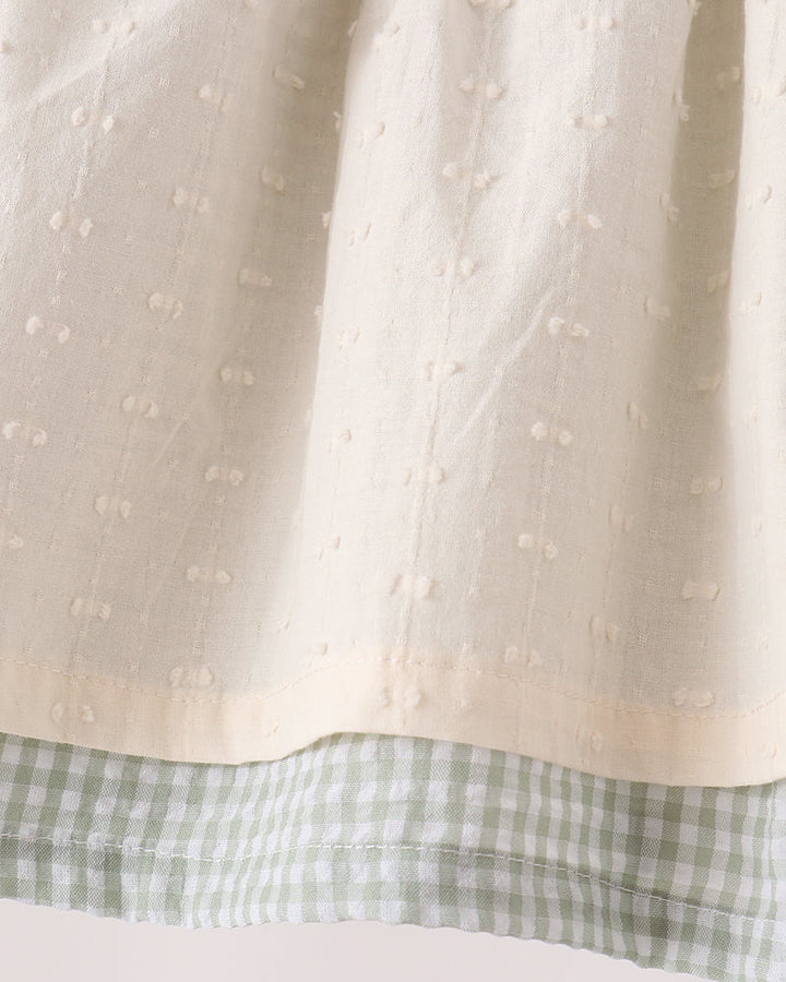 Cream dotted top with green gingham hem and elastic waist bloomer