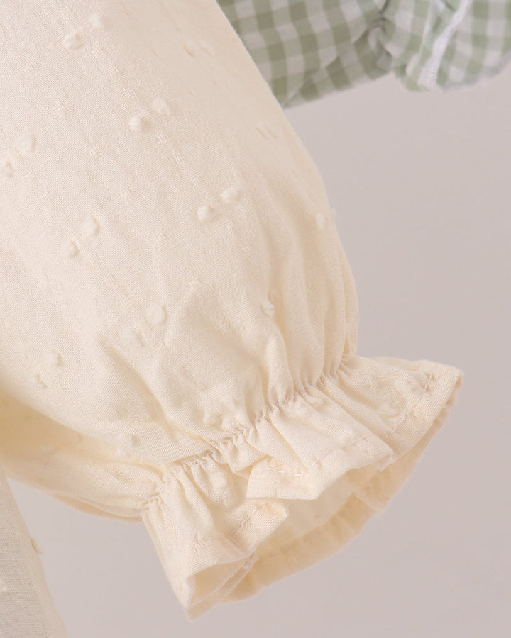 Cream long-sleeve top with elastic cuff ruffle