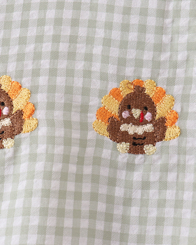 Embroidered turkey face patches on light green check gingham fabric
