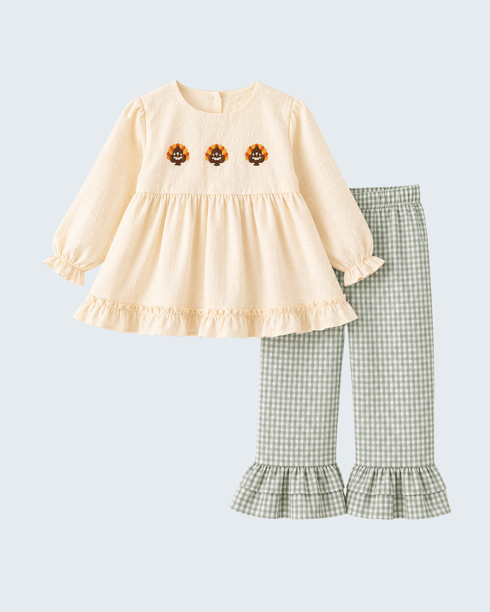 Cream ruffle dress with three embroidered flowers and green gingham flared pants