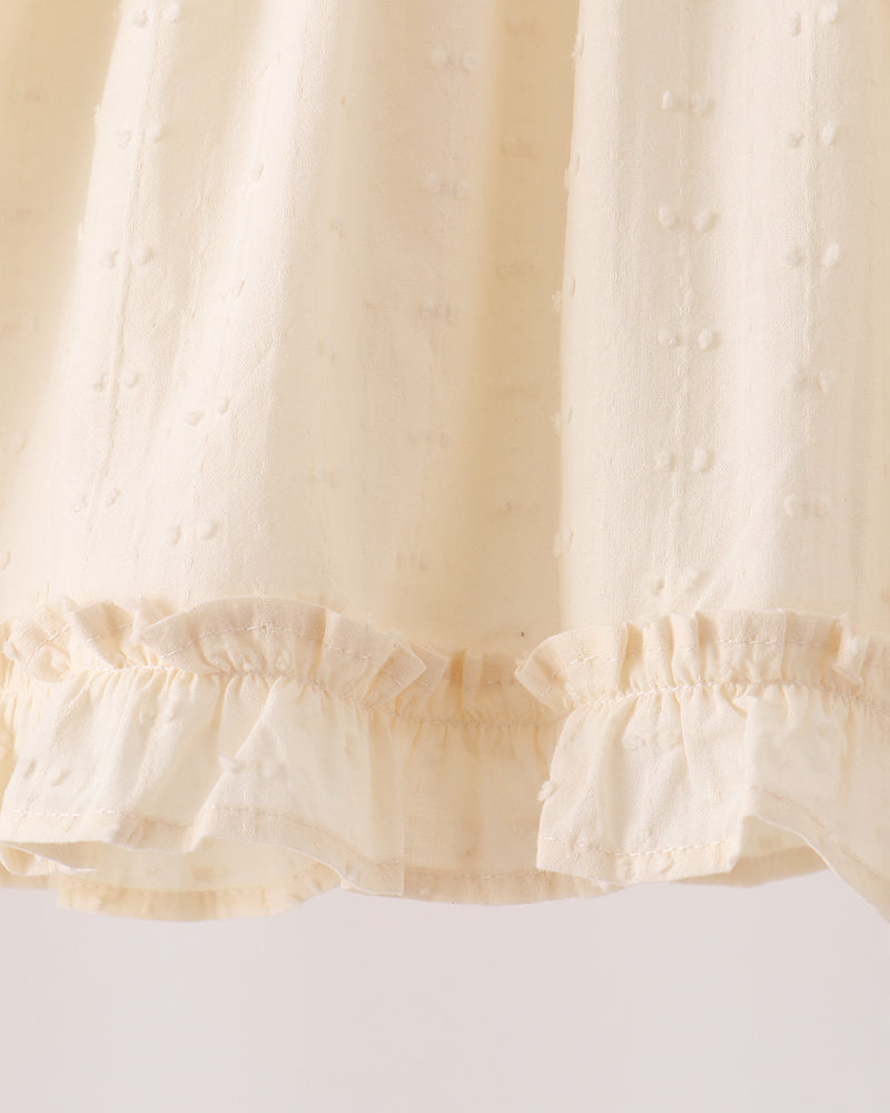 Cream ruffled elastic waistband and cuff trim on textured fabric