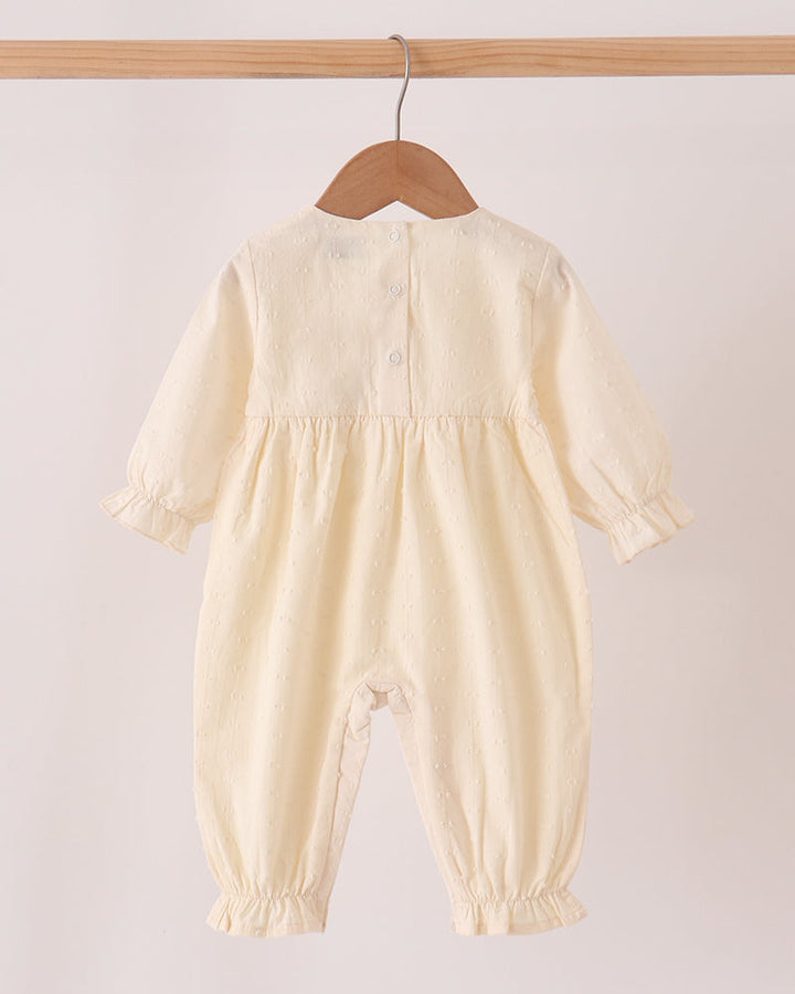 Cream baby romper with long sleeves and front button closure