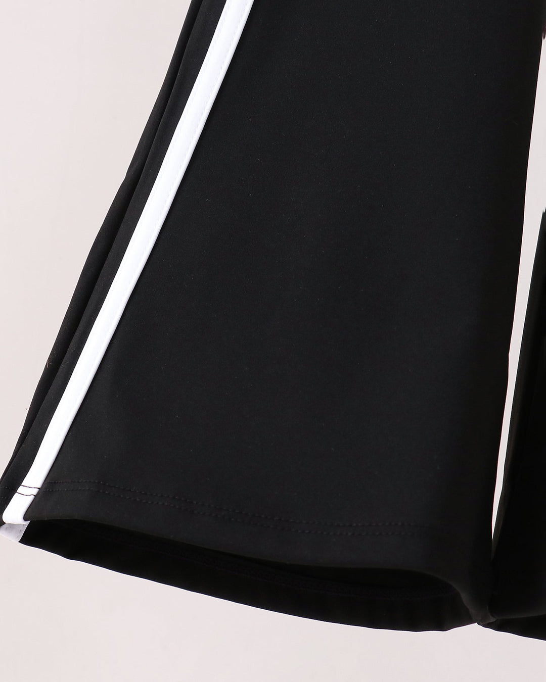 Black wide-leg pants with white side stripe detail at the hem