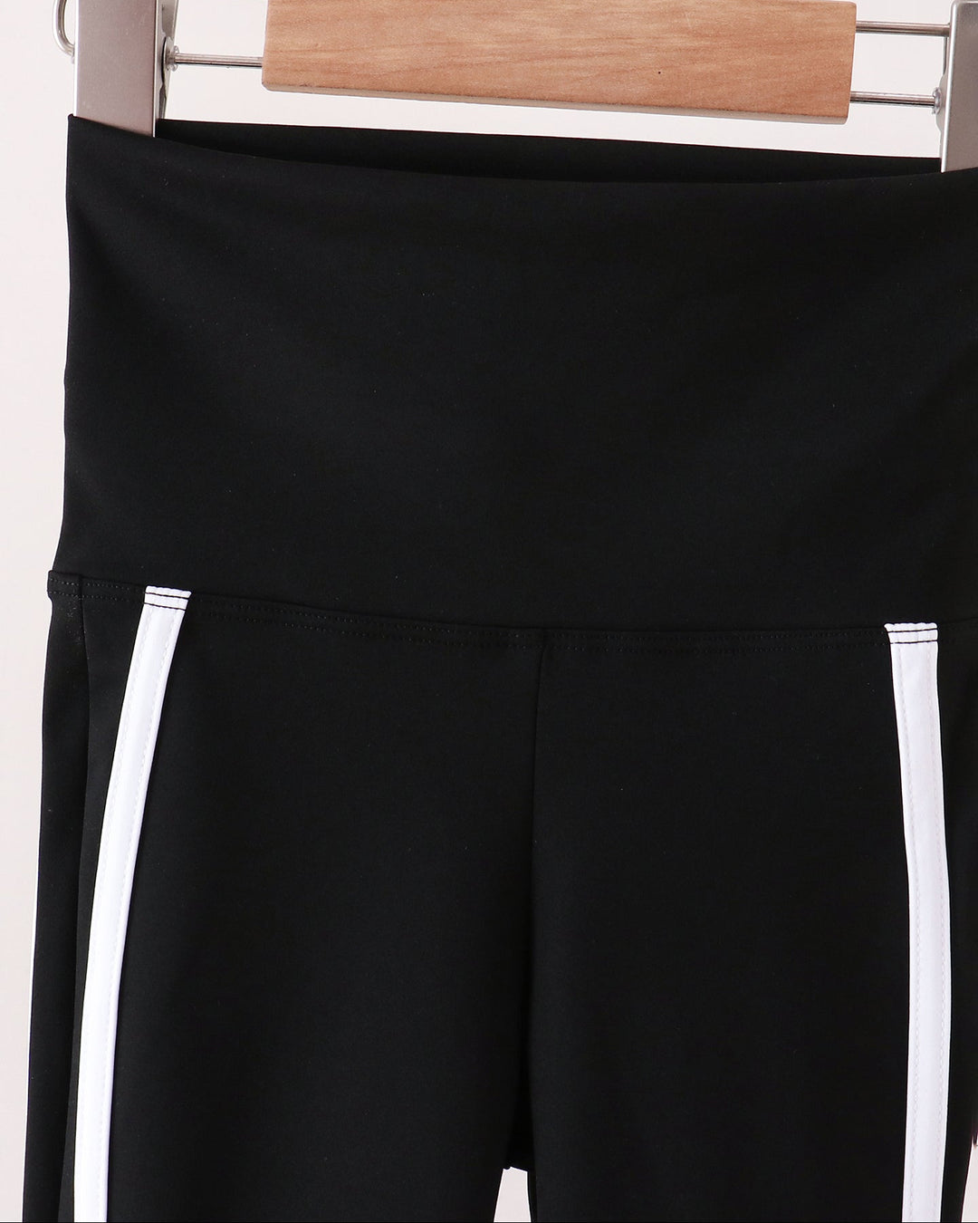 Black active pants with elastic waistband and two white side stripes